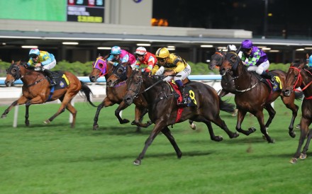 Genius Baby (centre) wins at Class Four level on Wednesday night. Photo: Kenneth Chan