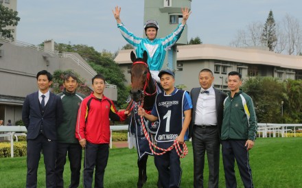 Jockey James McDonald, trainer Danny Shum (second from right) and stable staff celebrate Romantic Warrior’s fourth straight Hong Kong Cup success. Photos: Kenneth Chan