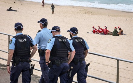 Australian police officers patrol near beachgoers at Sydney’s Bondi Beach on Thursday. Photo: AFP