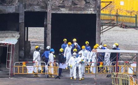 Members of the independent investigation committee of the Wang Fuk Court fire, wearing protective suits, inspect the fire scene on December 23. Photo: Jelly Tse