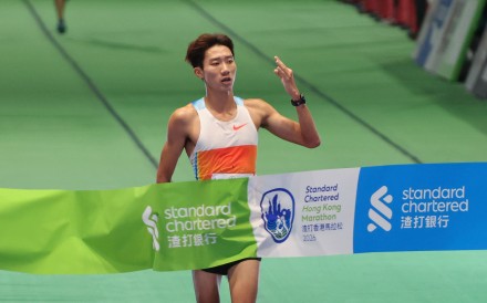 Hong Kong triathlete Wong Tsz-to reaches the 10km finish line first at Victoria Harbour Park. Photo: Dickson Lee