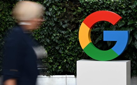 A woman walks past a Google logo at the company’s campus in Warsaw in February 2025. Photo: AFP