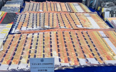 Stacks of money are displayed as evidence in a scam case. There were 43,212 scam cases last year, according to police. Photo: Handout