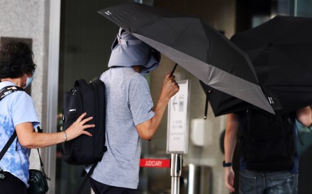 Kwok Yin-sang (centre) arrives at West Kowloon Court during the trial in October last year. Photo: Edmond So