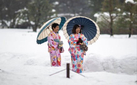 Tourists in traditional outfits visit the snow-covered Kanazawa Castle in Japan’s Ishikawa prefecture last month. Photo: AFP