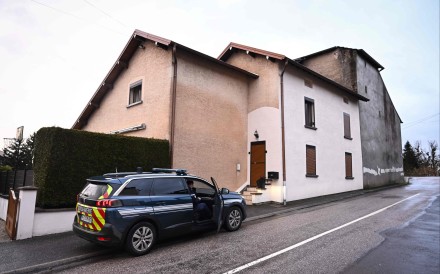 Law enforcement outside the house where the bodies of two infants were discovered in a freezer in Ailleviller-et-Lyaumont, eastern France on February 12, 2026. Photo: AFP
