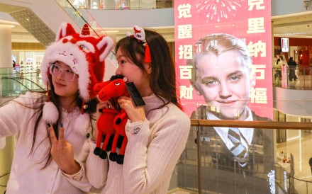 Shoppers take a selfie in front of a poster featuring Tom Felton as his Harry Potter character Draco Malfoy at a mall in Shangqiu, in China’s central Henan province. Find out more about how the Year of the Horse influences Chinese culture, from fireworks to linguistics, and why Draco Malfoy is an unexpected Lunar New Year icon. Photo: AFP