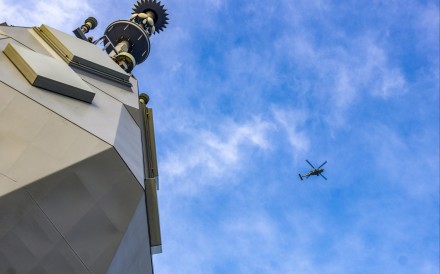 A Royal Australian Navy helicopter flies above the HMAS Toowoomba as it sails in the South China Sea. Photo: Handout