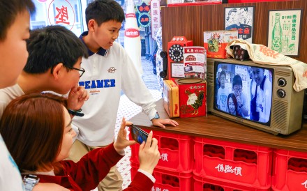 Tourists gather around an old-school display at a Wellcome supermarket in Hong Kong’s Yau Ma Tei neighbourhood. Similar retro-themed displays are popping up all over the city. Photo: Dickson Lee