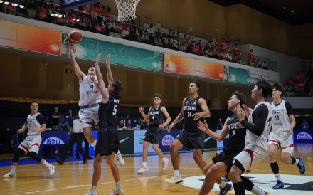 Hong Kong’s Tsang Cham-yuen tries to shoot against New Zealand’s Taylor Britt during their Fiba Asia Cup qualifier in February last year. Photo: Elson Li
