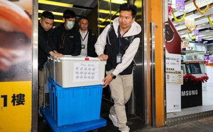 Police take away boxes from a law firm in Mong Kok during an operation last month. Photo: Handout 