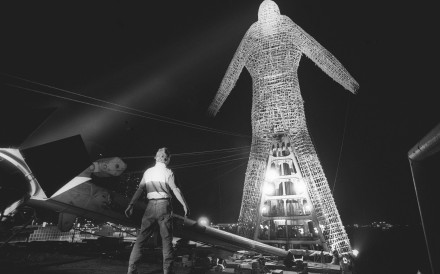 The Bamboo Man sculpture by multimedia artist André Heller is lit up in readiness for its journey across Victoria Harbour in May 1992. Photo: SCMP Archives