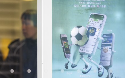 An advertisement for the Hong Kong Jockey Club’s eWin app at a betting branch in Sheung Wan on February 26. Photo: Eugene Lee
                                