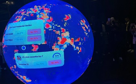 A LED sphere screen shows information at 
                                “The Situation Room”, a pop-up bar by prediction market platform Polymarket, in Washington on March 20. Photo: AFP