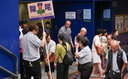 Residents queue up to buy Mark Six tickets on Saturday. Photo: Eugene Lee