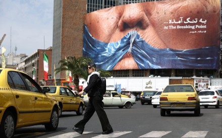 A woman walks past an anti-US billboard depicting US President Donald Trump and the Strait of Hormuz, in Tehran, Iran, on Saturday. Photo: Reuters