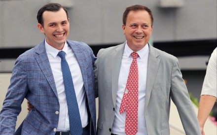 Caspar Fownes (right) and son Ronan celebrate the stable’s double at Sha Tin on Sunday. Photos: Kenneth Chan