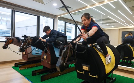 Apprentice jockeys Nichola Yuen (left) and Britney Wong practising on mechanical wooden horses at the Hong Kong Jockey Club's Apprentice Jockeys’ School in Sha Tin. Photo: Edmond So