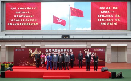 Zhang Yingxi (second from right) leads the singing of the national anthem during the opening ceremony of the Hong Kong Reunification Raceday at Sha Tin Racecourse. Photo: Kenneth Chan.