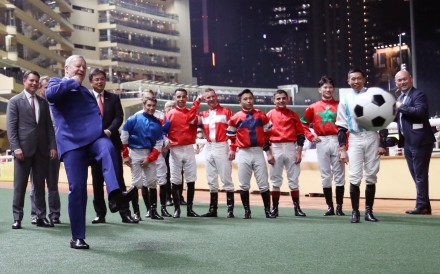 Jockeys watch on as Jockey Club chief executive Winfried Engelbrecht-Bresges (left) shoots for goal before the "Eight To Glory" race at Happy Valley. Photos: Kenneth Chan