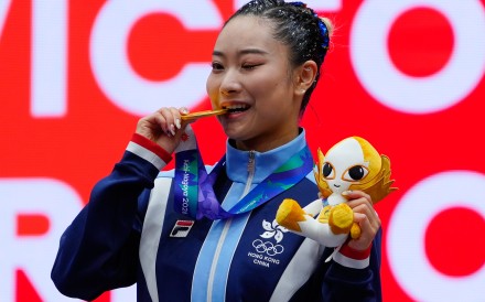Lydia Sham celebrates  women’s wushu changquan gold at the Asian Games. Photo: AP