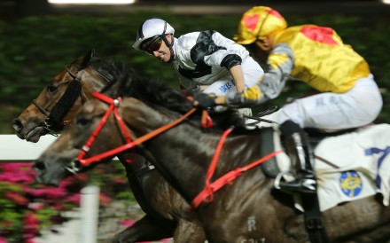 Neil Callan lifts Jolly Convergence to victory at Happy Valley on Wednesday night. Photos: Kenneth Chan