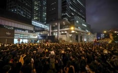 As night falls, protesters are still outside the police headquarters in Wan Chai. Photo: Edmond So
