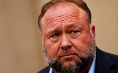 Infowars founder Alex Jones speaks to the media after appearing at his Sandy Hook defamation trial in Waterbury, Connecticut, in October. Photo: Reuters