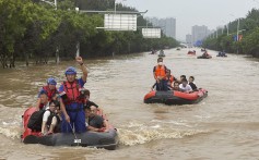 Residents are evacuated on rubber boats through floodwaters in the northern Chinese city of Zhuozhou, Hebei province, in August. Photo: AP