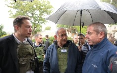 Israel’s Prime Minister Benjamin Netanyahu, centre, takes billionaire Elon Musk, left, on a tour of Kibbutz Kfar Aza in Israel on Monday. Photo: Amos Ben-Gershom (GPO) Handout via Getty Images / TNS
