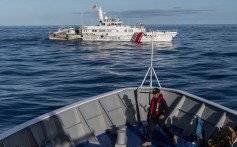 A China coastguard ship moves past a Philippine coastguard vessel BRP Sindangan, in the disputed Second Thomas Shoal, in the South China Sea. Photo: Bloomberg