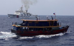 A Philippine supply boat sails near a Chinese Coast Guard ship during a resupply mission for Filipino troops stationed at a grounded warship in the South China Sea in October. Photo: Reuters
