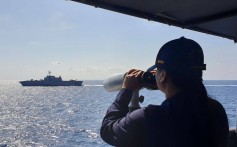 A service member from the Philippine Navy keeps watch as a US littoral combat ship sails past during a joint “maritime cooperative activity” in the South China Sea on February 9. Photo: Armed Forces of the Philippines’ Western Command / Handout via AFP