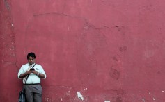 A man in Colombo, Sri Lanka, uses his mobile phone. Beijing is actively exporting its internet successes, empowering businesses to transact online through the same tools developed in China. Photo: Reuters