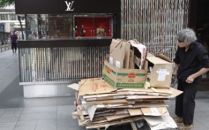 An elderly low-income earner pushes a trolley with cardboard bundles in Hong Kong's Central district. Among Asian cities, Hong Kong ranked below Tokyo, Singapore, Seoul and Bangalore in terms of quality of life. Photo: EPA