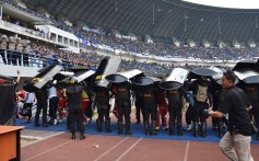 Indonesia riot police stand guard during a match between Persija and Bandung, before which a Persija fan Haringga Sirla was beaten to death. Photo: AFP
