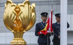 Officers raise the Chinese flag during a ceremony at the Golden Bauhinia Square in Wan Chai. Photo: Robert Ng