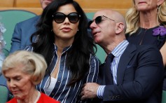 Jeff Bezos (right) with Lauren Sanchez as they watch Saturday’s men’s singles tennis final at the Wimbledon tennis championships in England. Photo: Reuters