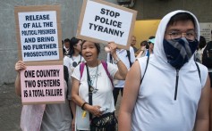 Demonstrators hold signs during a protest organised by the elderly in the central district of Hong Kong. Photo: Bloomberg