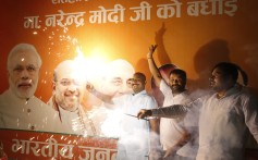 Supporters of India's ruling Bharatiya Janata Party celebrate the government’s revocation of Kashmir's special status, in Lucknow. Photo: AP