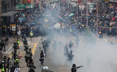Riot police run towards anti-government protesters in Sham Shui Po during another day of clashes across Hong Kong on Sunday. Photo: Felix Wong