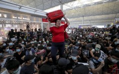 A passenger furious at the disruption tries to get through the mass of protesters in her path at Hong Kong airport’s departures. Photo: Sam Tsang