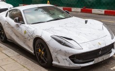 A Ferrari 812 Superfast supercar covered in marble-patterned vinyl – the latest fad for ultra-rich car owners – parked in London. Photos: Luxurylaunches