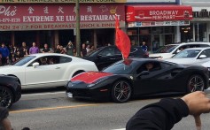 A Ferrari draped in Chinese flags drives past Hong Kong protesters and pro-China counterprotesters on Vancouver's Broadway on Saturday afternoon. Photo: Kevin Huang Yi Shuen