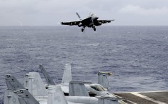 A US fighter jet prepares to land on the aircraft carrier USS Ronald Reagan following a patrol at international waters off the South China Sea. Photo: AP