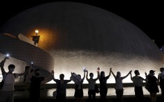 Demonstrators link hands as they gather at the Hong Kong Space Museum in Tsim Sha Tsui on August 23. At least 210,000 people joined human chains on both sides of Victoria Harbour on the day, in a gesture of support for the demands of Hong Kong protesters. Photo: AP