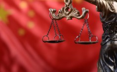 The Scales of Justice and Lady Justice in front of China’s national flag. Photo: Alamy