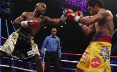 Floyd Mayweather Jr (left) exchanges punches with Manny Pacquiao during their welterweight unification championship bout, May 2, 2015 at MGM Grand Garden Arena in Las Vegas, Nevada, the US. Photo: AFP