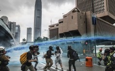 A police water cannon is used on protesters in Admiralty on August 31, against the backdrop of iconic buildings in Hong Kong’s central business district. Photo: Sam Tsang