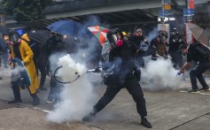 Masked protesters react to tear gas in Hong Kong on Sept. 29. Photo: Sam Tsang